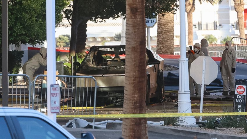 Investigators photograph a Tesla Cybertruck that exploded outside the lobby of President-elect Donald Trump’s hotel on January 1, 2025, in Las Vegas. At least one person was killed and seven wounded when a Tesla Cybertruck exploded outside a hotel belonging to US President-elect Donald Trump in Las Vegas, police said Wednesday. (Photo by WADE VANDERVORT / AFP) (Photo by WADE VANDERVORT/AFP via Getty Images)