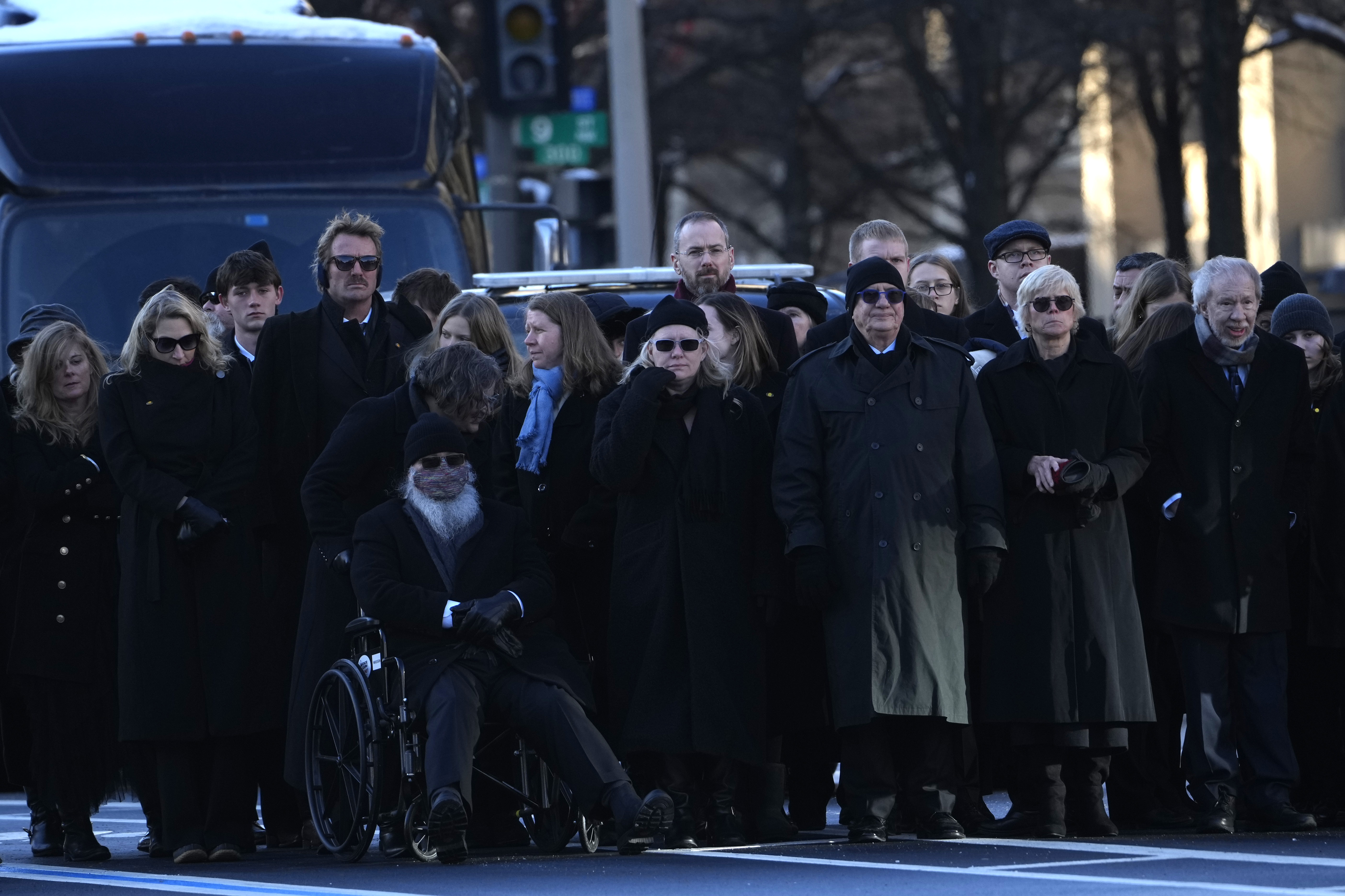 Members of the Carter family watch as Carter’s casket sits on a horse-drawn caisson in front of the U.S. Navy Memorial.