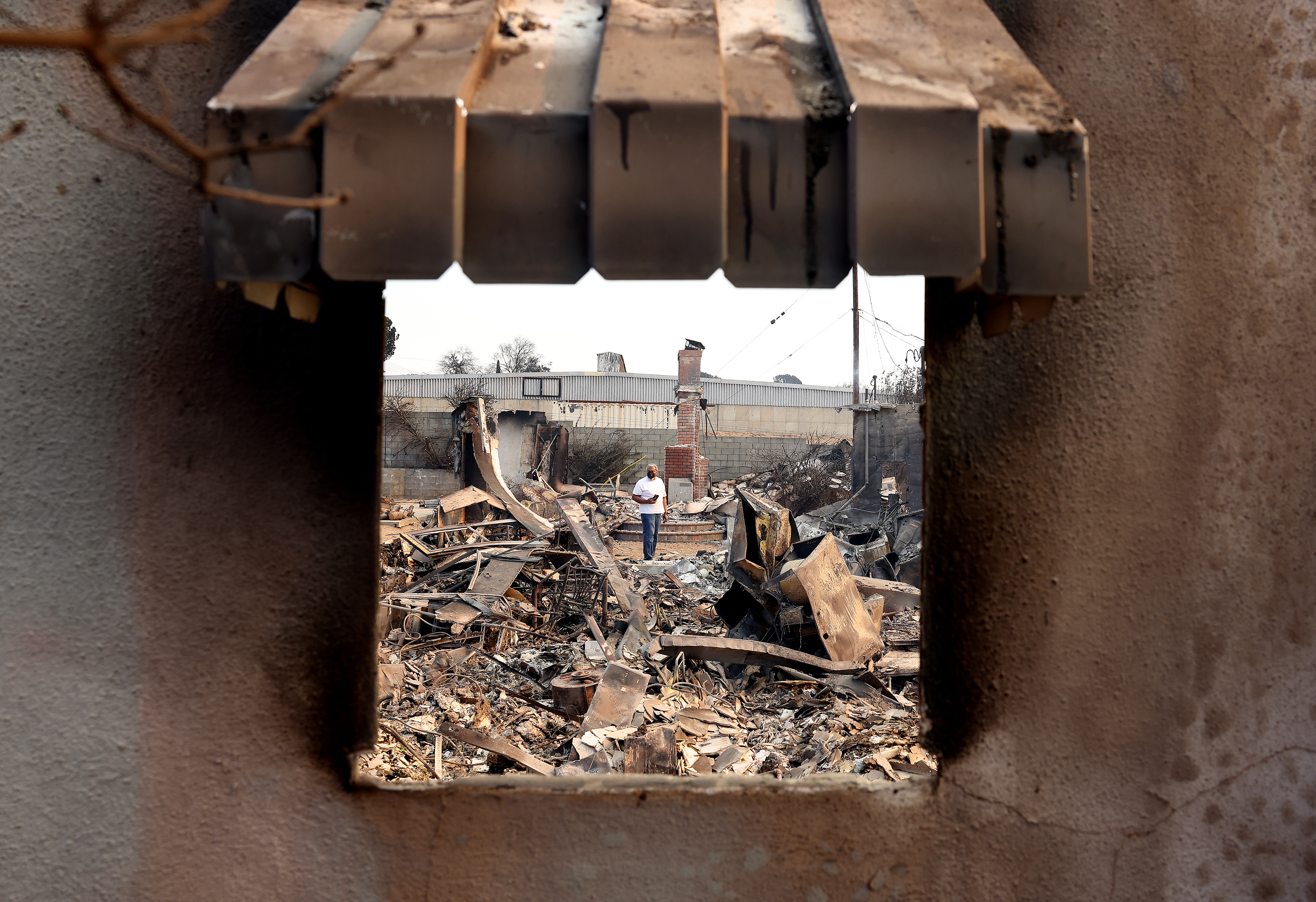 William Harris, 63, assesses the damage of his home that was burned down by the Eaton Fire in Altadena on Jan. 9, 2025.