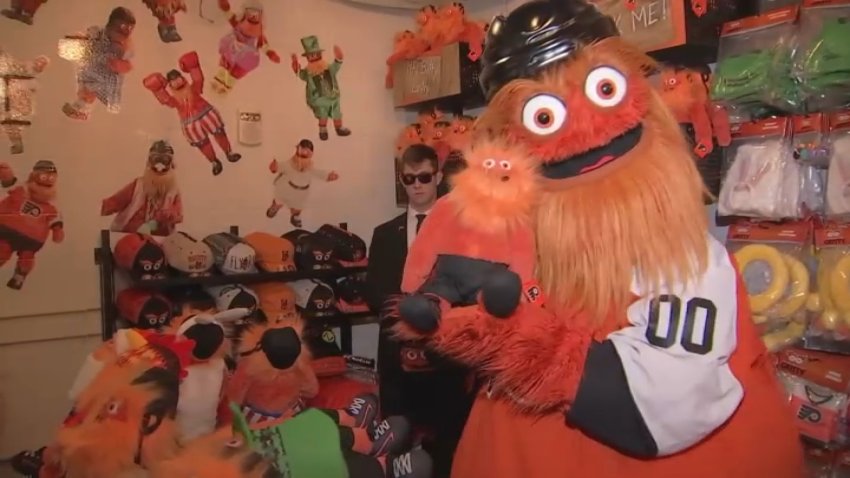 Gritty with Gritty doll and security guard