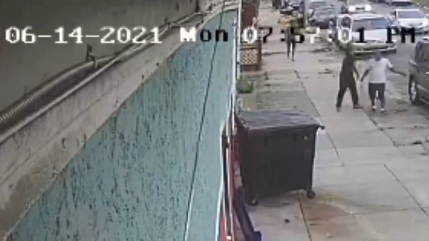 A still from surveillance footage shared by the District Attorney's Office that shows the moments before a shooting outside a barbershop in West Philly in 2021.