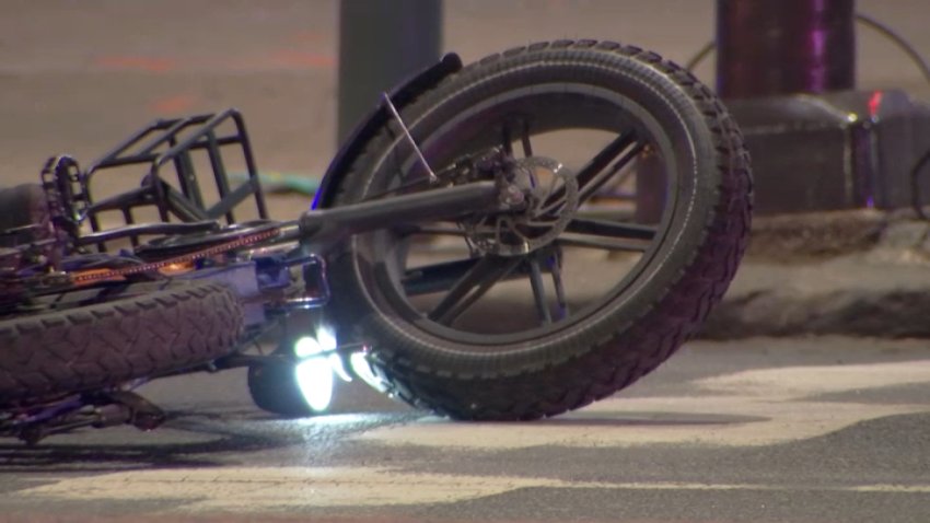 An electric bike rests along Broad Street on Monday, Jan. 6, 2025, after a man was killed in a crash while riding it along the roadway.