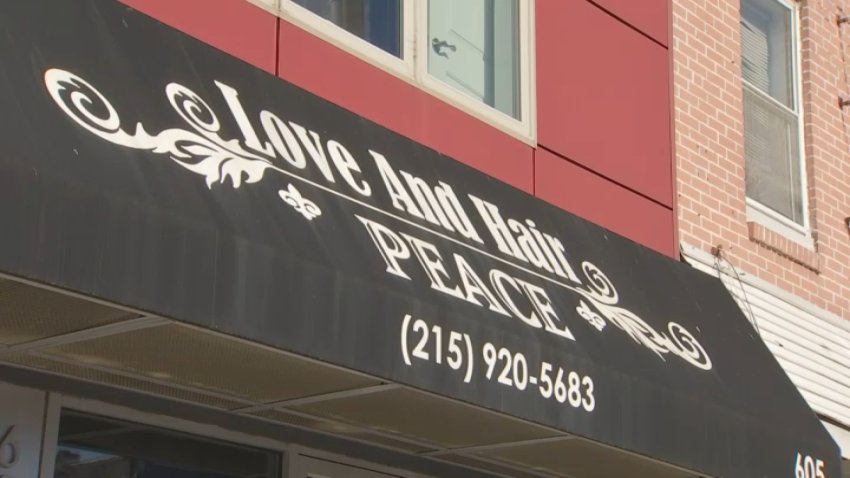 Sign reads "Love and Hair Peace"