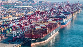 Cargo ships and containers at Qingdao port in eastern China’s Shandong province on Dec. 4, 2024.