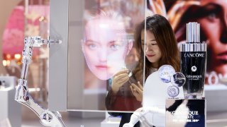 A woman view skin care products at L’Oreal booth during the 7th China International Import Expo (CIIE) at the National Exhibition and Convention Center (Shanghai) on November 5, 2024 in Shanghai, China.