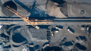 Piles of coal waiting to be transported at Guoyuan Port container terminal in Chongqing, China.