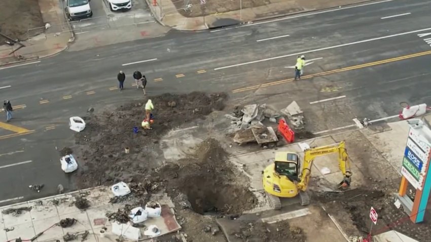 Crews work on Monday at the Roosevelt Mall in Northeast Philadelphia to repair a crater left in the ground after a plane crashed there on Friday, Jan. 31, 2025.