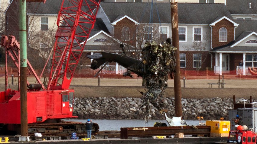 Rescue and salvage crews pull up a part of an Army Black Hawk helicopter after a fatal crash over the Potomac River, Feb. 6, 2025, in Arlington, Va.