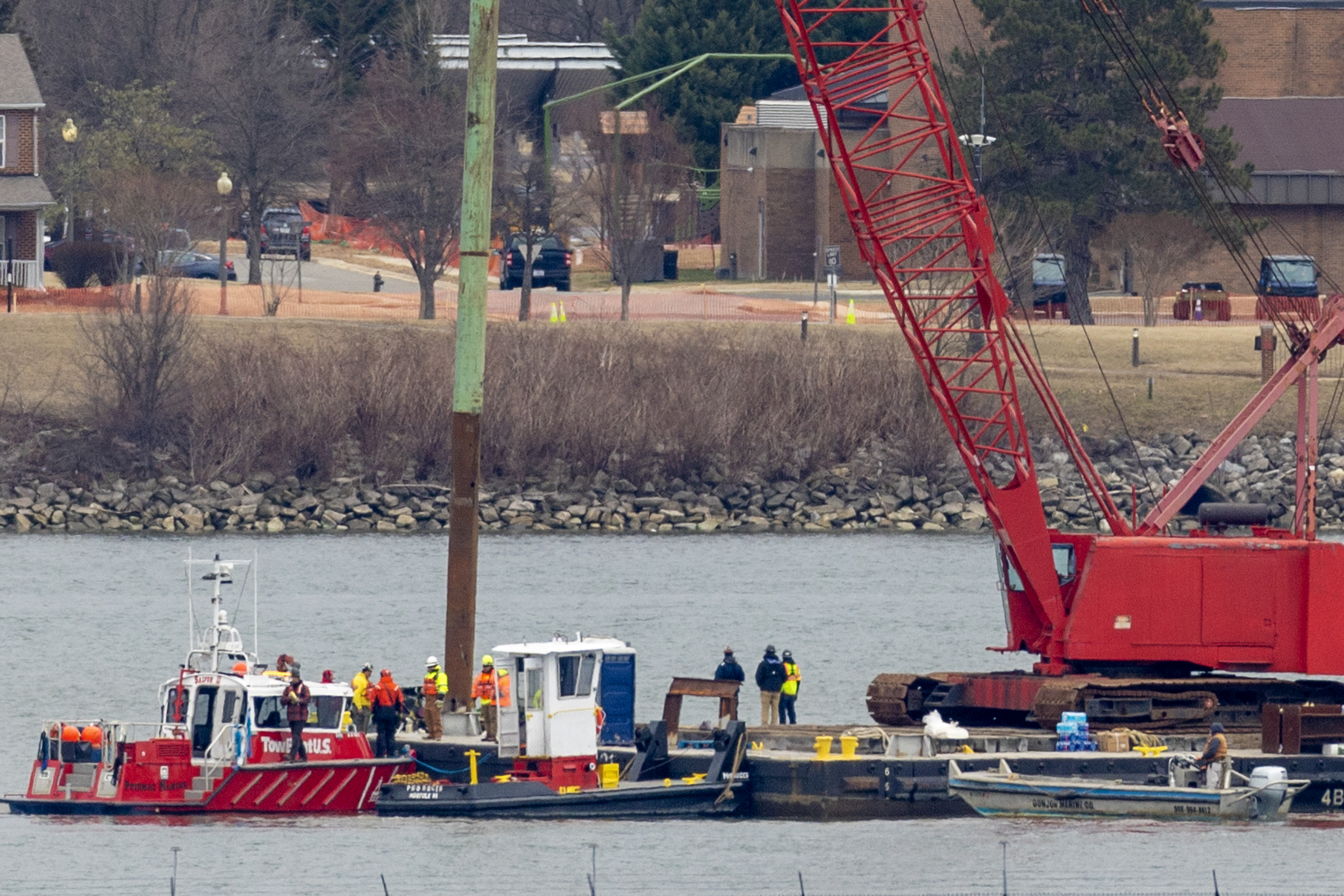 ARLINGTON, VIRGINIA - FEBRUARY 02: A crane moves in to place on the Potomac River for recovery efforts on February 02, 2025 in Arlington, Virginia. An American Airlines flight from Wichita, Kansas collided midair with a military Black Hawk helicopter while on approach to Ronald Reagan Washington National Airport on January 29, 2025 outside of Washington, DC. According to reports, there were no survivors among the 67 people onboard both aircraft. (Photo by Tasos Katopodis/Getty Images)