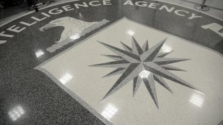 File. The logo of the CIA is seen during a visit ofUS President Donald Trump the CIA headquarters on January 21, 2017 in Langley, Virginia .  Trump spoke with about 300 people in his first official visit with a government agaency.