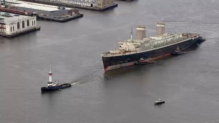 The SS United States is towed down the Delaware River on its final voyage before it becomes an artificial reef.