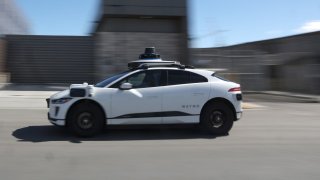 A Waymo car drives along a street in San Francisco on March 1, 2023.