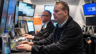 Traders work on the floor of the New York Stock Exchange on Feb. 13, 2025