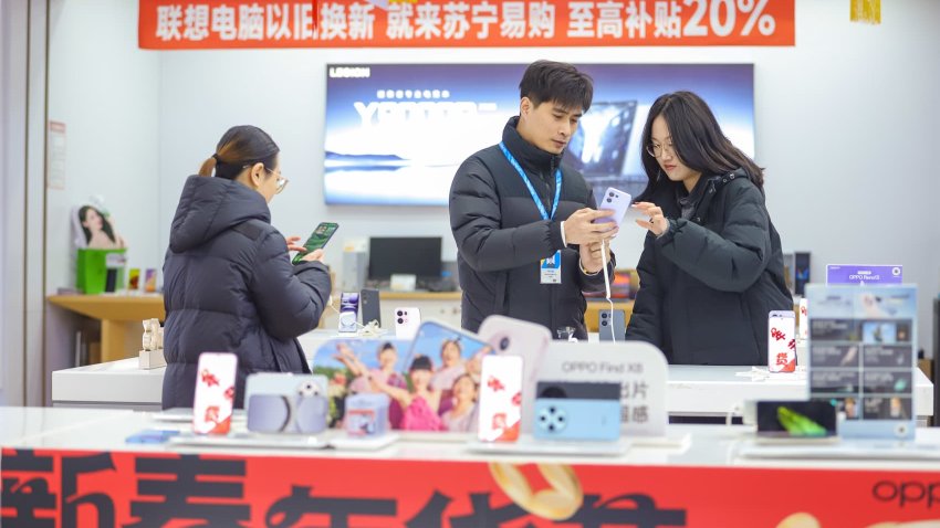 QINGDAO, CHINA – JANUARY 08: Customers browse at an electronics shop amid an ongoing nationwide trade-in subsidy program on January 8, 2025 in Qingdao, Shandong Province of China.  