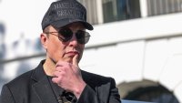 Tesla CEO Elon Musk watches as President Donald Trump talks to the media, outside the White House in Washington, D.C., March 11, 2025.