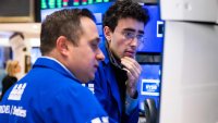 Traders work on the floor of the New York Stock Exchange on March 13, 2025.