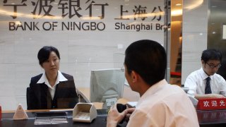 Shanghai, CHINA: A Chinese customer at a branch of the Bank of Ningbo on the eve of it’s IPO in Shanghai 18 July 2007.