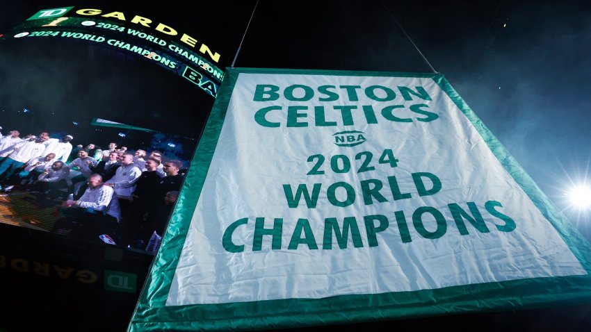 The Boston Celtics hang the 2024 NBA championship banner at TD Garden.