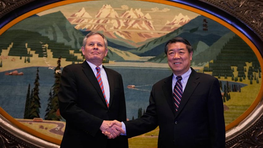 Chinese Vice Premier He Lifeng (R) shakes hands with US Senator Steve Daines before a meeting held in the Xinjiang Room at the Great Hall of the People in Beijing on March 22, 2025. 