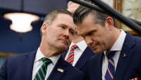 (L-R) US National Security Advisor Mike Waltz speaks with Defense Secretary Pete Hegseth as US President Donald Trump meets with French President Emmanuel Macron in the Oval Office of the White House in Washington, DC, on February 24, 2025. 