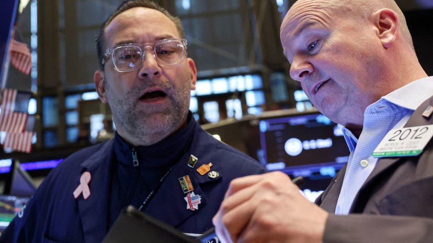 Traders work on the floor at the New York Stock Exchange in New York City, U.S., March 27, 2025.