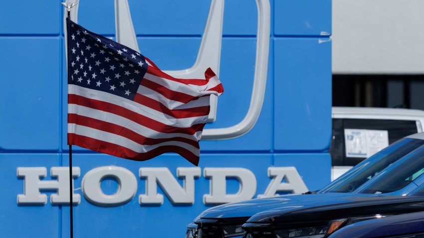 An American flag flutters outside a Honda automobile dealership in Irvine, California, U.S., March 27, 2025. 