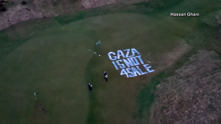 An aerial view of a golf course with graffiti on it.