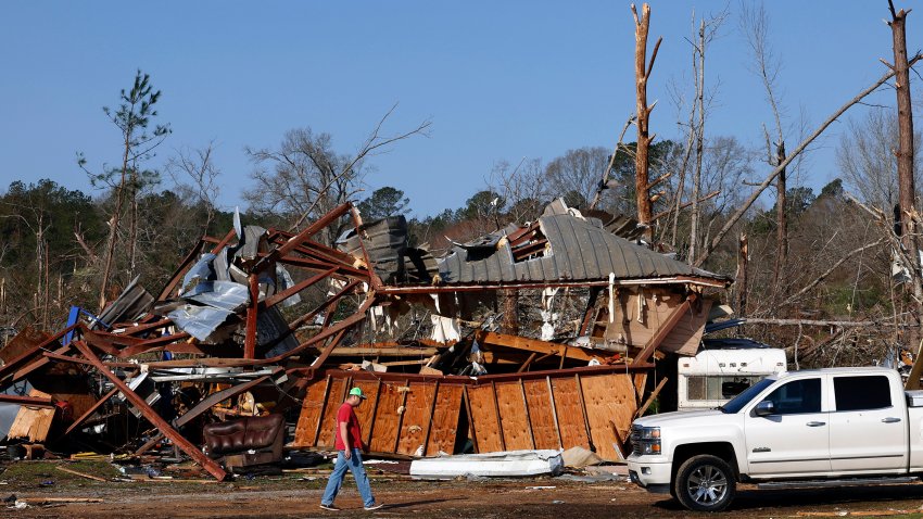 Residents look for personal belongings in the damage after