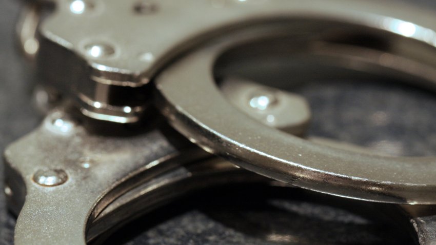 A close up shot of a pair of handcuffs on a table.