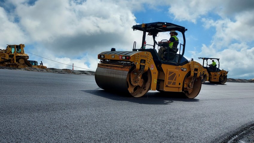 A steamroller going over asphalt.