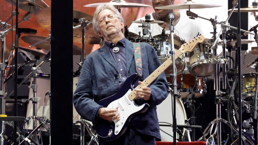 Eric Clapton playing guitar on stage