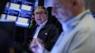 Traders work on the floor at the New York Stock Exchange on April 14, 2025.
