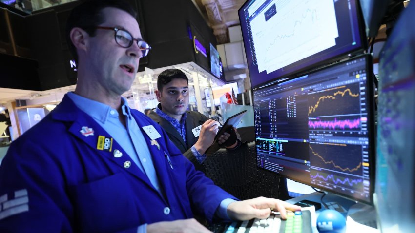 Traders work on the floor of the New York Stock Exchange during morning trading on April 22, 2025 in New York City.