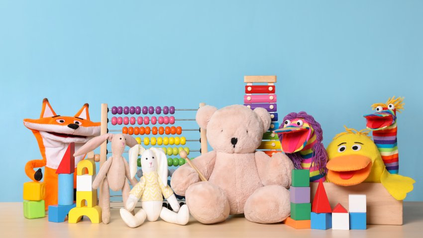 Collection of different toys on wooden table