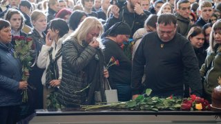 Relatives and friends attend the farewell ceremony for 17-year-old Danylo Khudei and his parents, father Oleh and mother Viktoriia, who were killed during a Russian missile strike on April 28, 2025 in Kyiv, Ukraine.