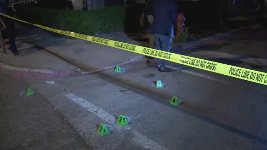 Police tape and evidence markers on dark street