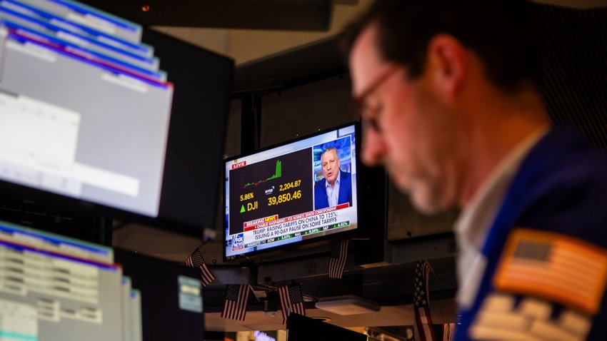A television broadcasts market news as a trader works on the floor of the New York Stock Exchange (NYSE) on Wednesday, April 9, 2025.