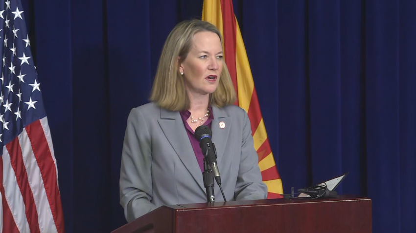 Arizona Attorney General Kris Mayes speaks at lectern
