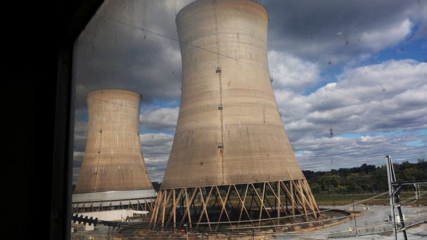 Cooling towers are seen through a window at the Three Mile Island Nuclear power plant, during a tour by Constellation Energy, which has ordered a main power transformer for the nuclear reactor it is trying to reopen, in Middletown, Pennsylvania, on Oct. 16, 2024.