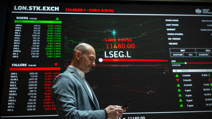 A member of staff next to a trading board at the London Stock Exchange on April 25, 2025.