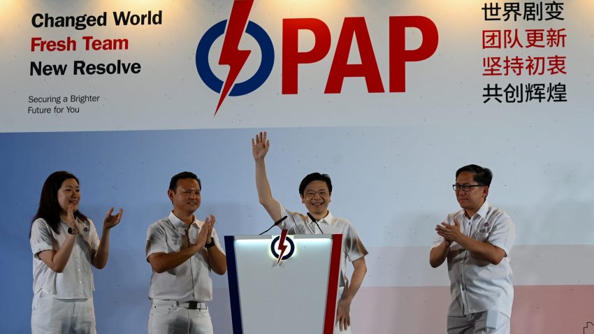 Singapore Prime Minister Lawrence Wong of the People’s Action Party (PAP) waves to supporters as he celebrates at the party’s gathering centre during the general election results, in Singapore on May 3, 2025. Singapore’s ruling party headed for a crushing victory at general elections on May 3, sample counts showed, with voters giving Prime Minister Lawrence Wong the clear mandate he was seeking.