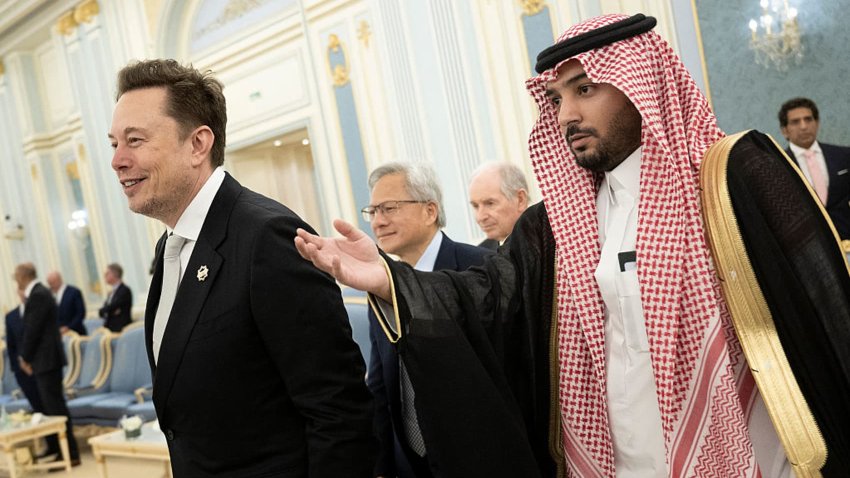 Senior Advisor to the U.S. President Elon Musk (L) and Nvidia CEO Jensen Huang (C) are directed to greet the Saudi Crown Prince at the Royal Court in Riyadh on May 13, 2025.