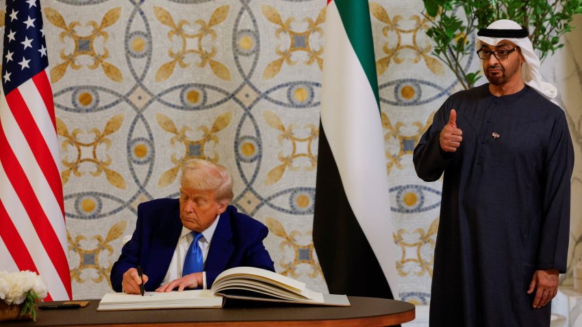 U.S. President Donald Trump signs a guest book next to United Arab Emirates President Sheikh Mohamed bin Zayed Al Nahyan, at Qasr Al Watan, in Abu Dhabi, United Arab Emirates, May 15, 2025.