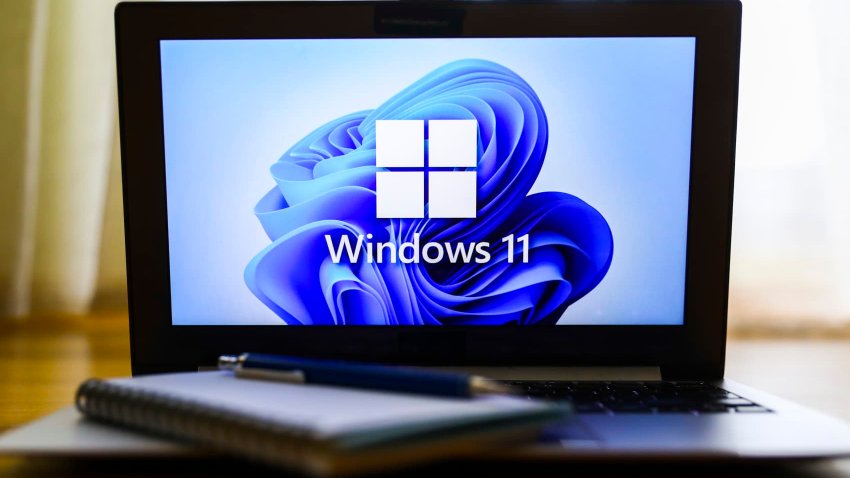 Windows 11 operating system logo is displayed on a laptop screen for illustration photo.