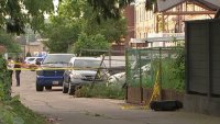 Police investigate in an alleyway after a body was discovered behind a Dunkin' coffee shop in Mayfair on Tuesday morning.