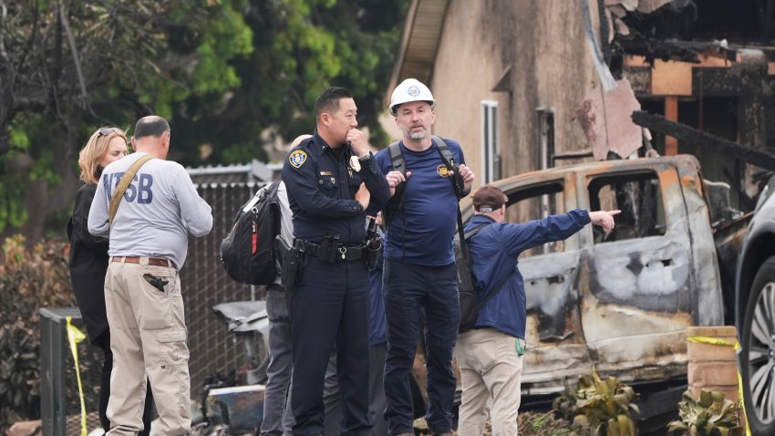 Investigators work at the site of a plane crash Friday, May 23, 2025, in San Diego.