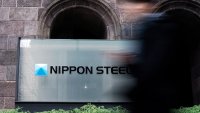 FILE - A person walks past a Nippon Steel Corporation sign at the company headquarters on Jan. 7, 2025, in Tokyo.