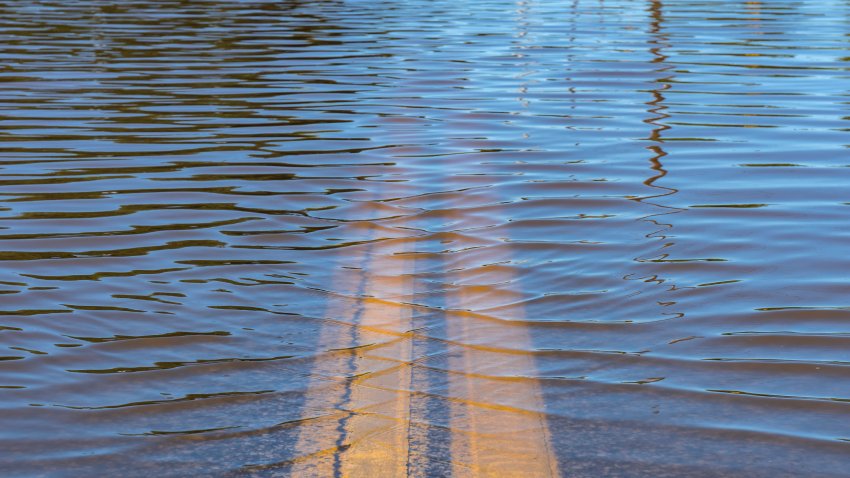 Closeup of high water flooding on neighborhood street.