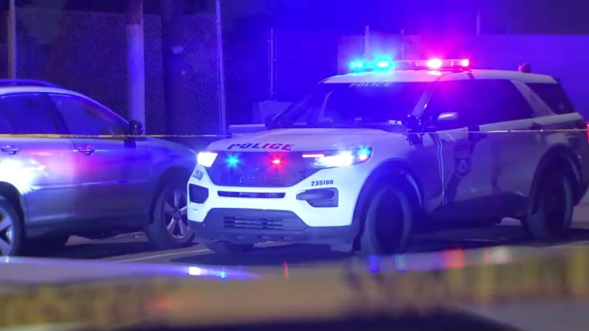 Police SUV with lights on behind yellow tape