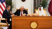 President Donald Trump, center, Qatar's Emir Sheikh Tamim bin Hamad Al Thani and Kelly Ortberg, President and Chief Executive Officer, The Boeing Company, left, share a moment during a signing ceremony at the Amiri Diwan in Doha, Qatar, Wednesday, May 14, 2025.